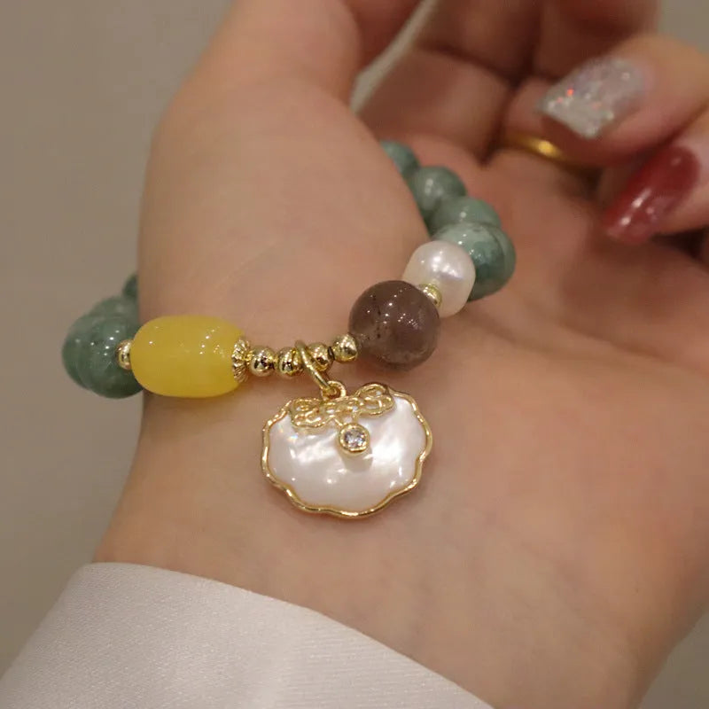 Green jade shell bracelet on a wrist showing natural stone beads and 18 cm length.