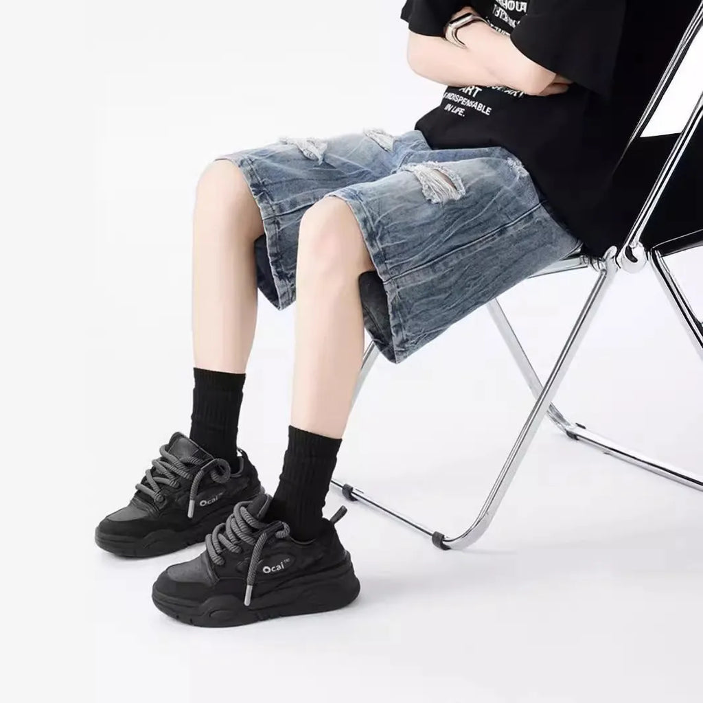 Women's distressed denim shorts with ripped detailing and washed vintage finish in loose retro fit