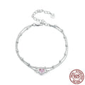 Women's sterling silver bracelet with a small heart-shaped charm on an adjustable chain.
