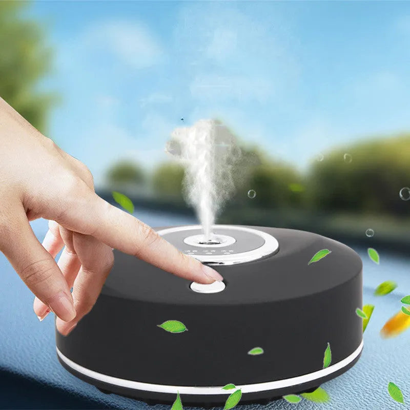 White plastic USB car air freshener diffuser with charging cable and anti-slip pad on a car dashboard.