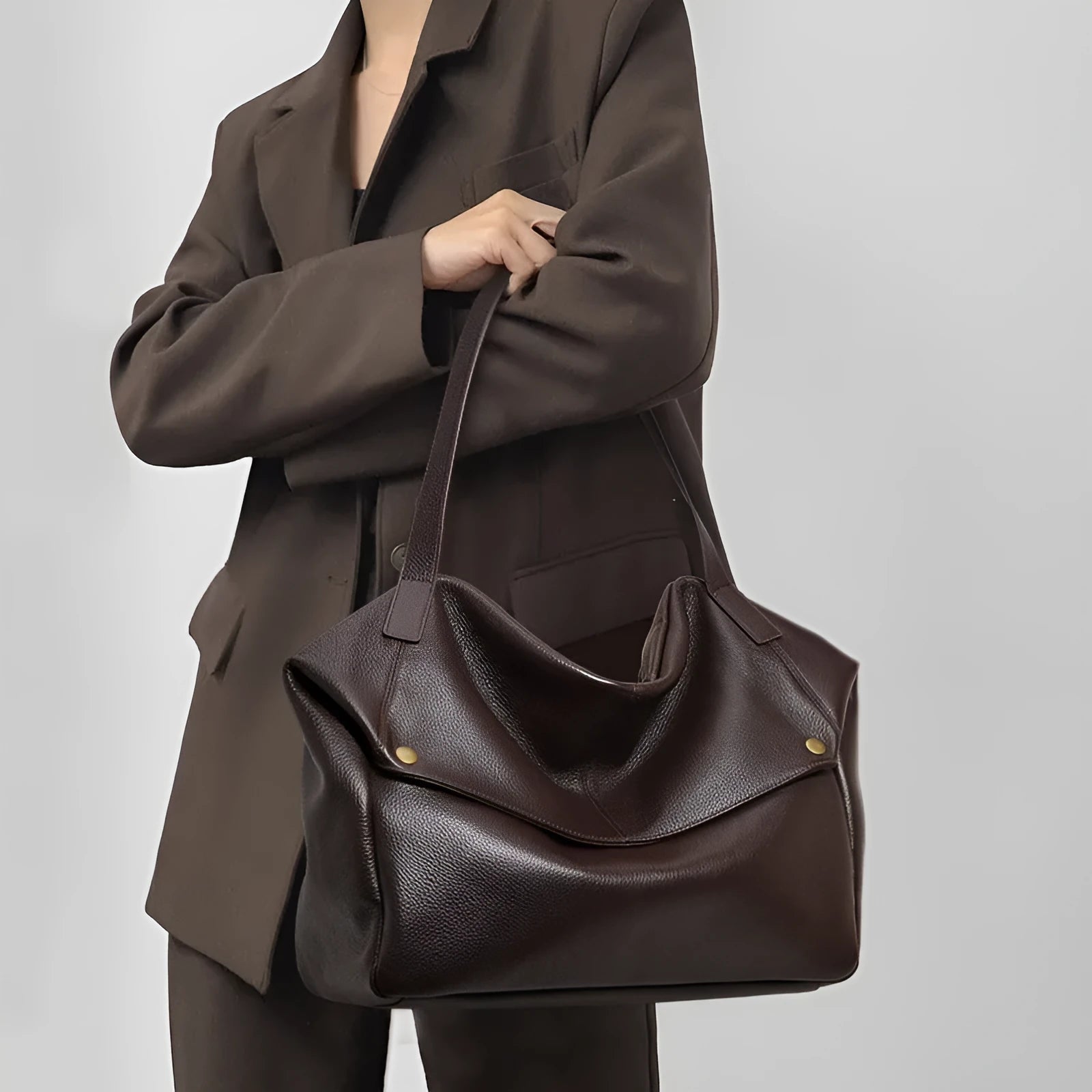 Brown genuine leather women's commuter shoulder bag with horizontal square shape showing interior zipper change pocket