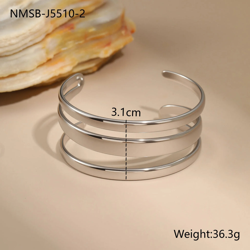 Women's stainless steel opening bracelet with geometric line design in gold or steel colour with 18K electroplated finish
