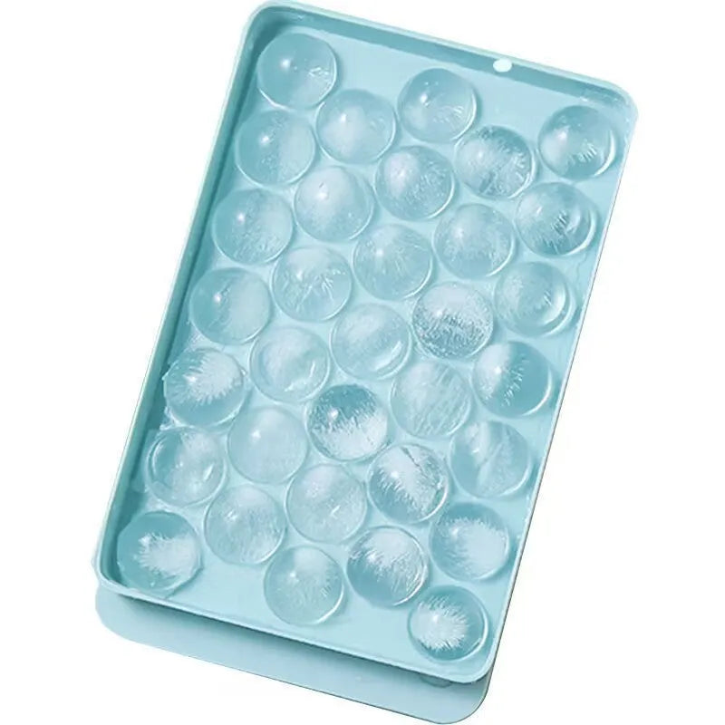 Blue round silicone ice cube tray with lid showing 33 large cavities, dimensions 24x14cm.