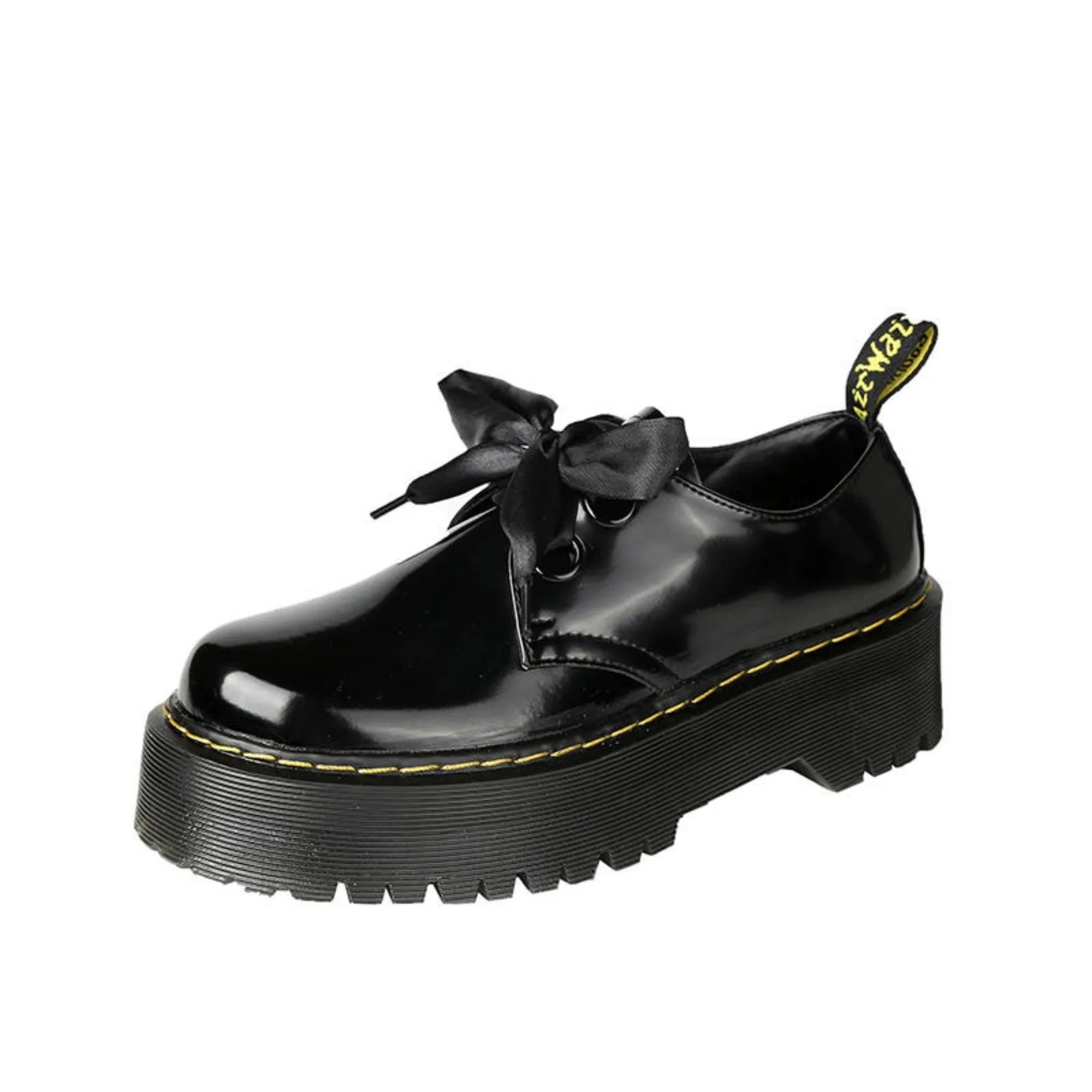 Women's white and black leather shoes with thick soles, ribbon and cross-strap design, and laced closure.