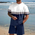 Man wearing a loose-fit light blue short-sleeve top and matching shorts from a polyester summer lounge set.