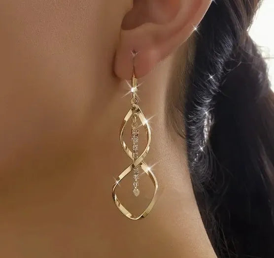 Gold-colour geometric earrings with a creative spiral and elliptical design for women.