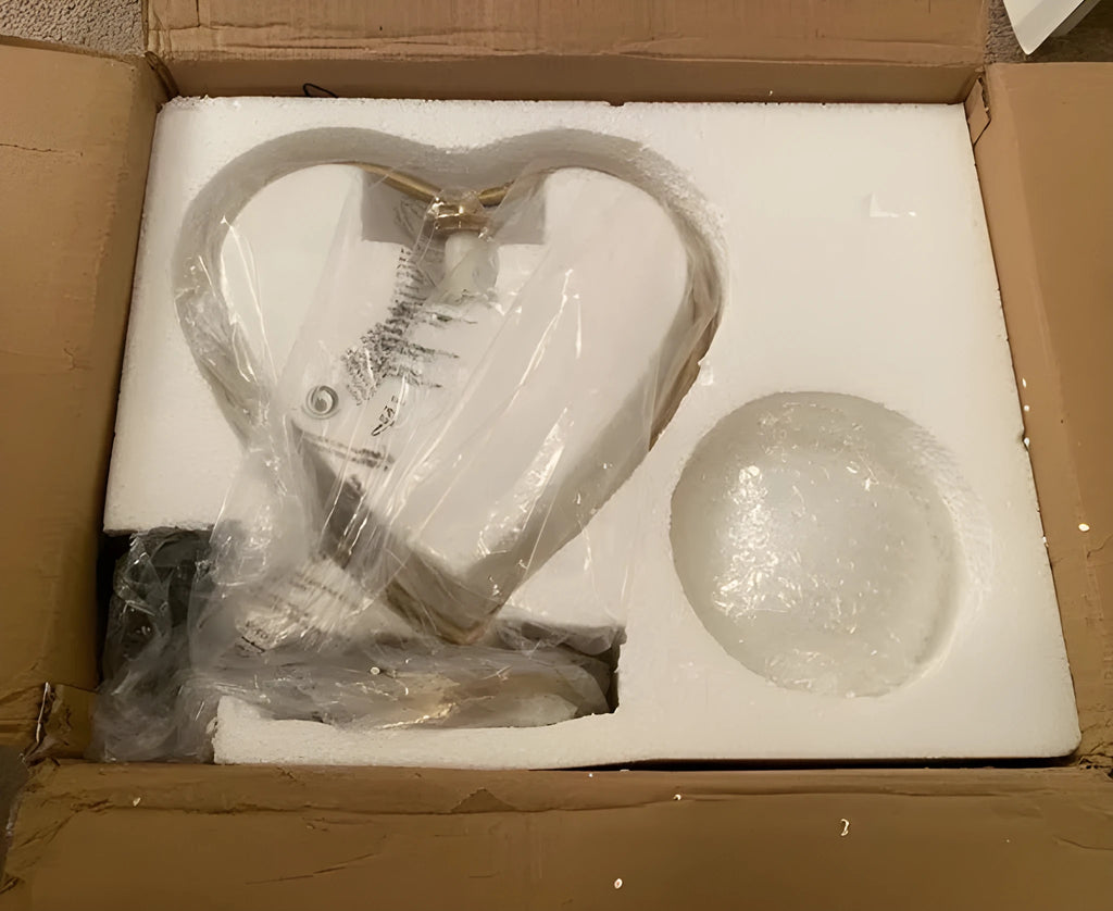 White heart shaped acrylic table lamp with LED light on a wooden surface