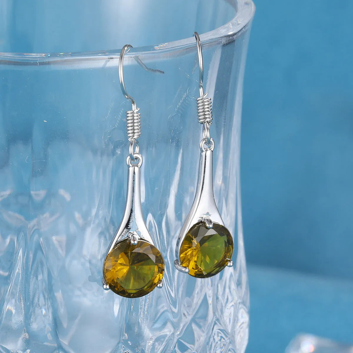 Olive green topaz water drop shaped earrings with electroplated finish and retro styling