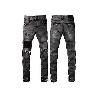 Black slim fit skinny jeans on a man, showing straight leg cut and manual distressing details.
