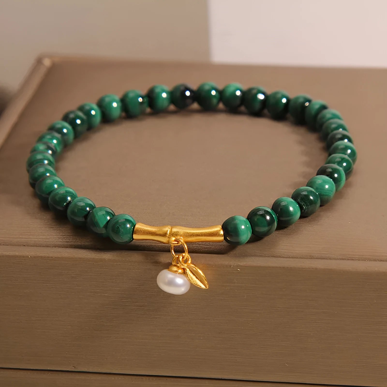 Women's white crystal bracelet with a raised lucky bamboo design centrepiece.