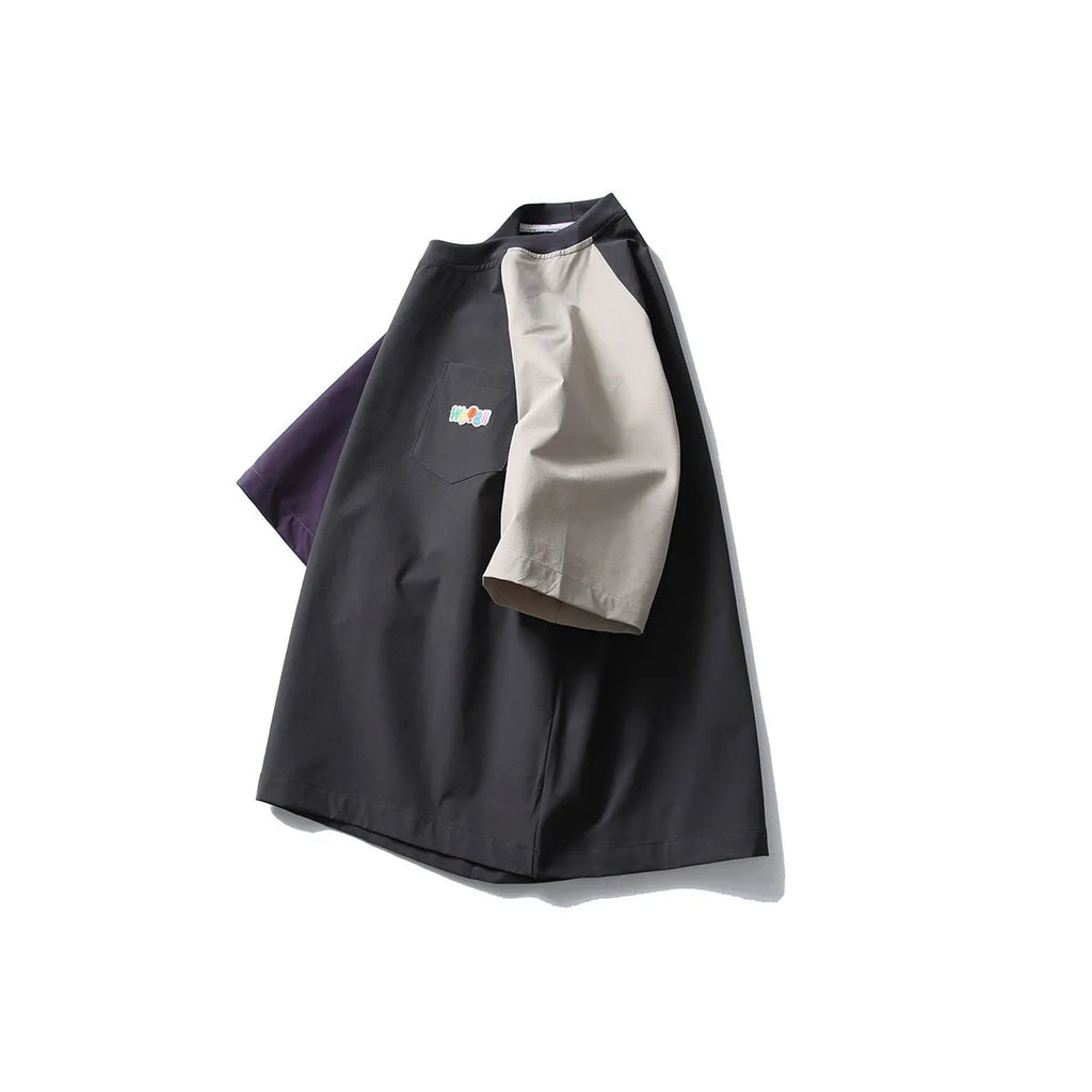 Dark grey loose fit T-shirt with contrasting colour raglan short sleeves on a hanger