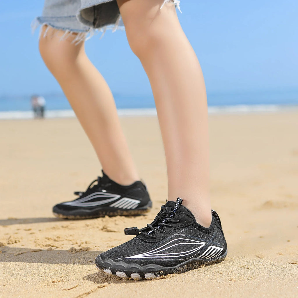 Children's quick-dry wading shoes in blue with rubber sole and elastic band, shown on a child's foot.