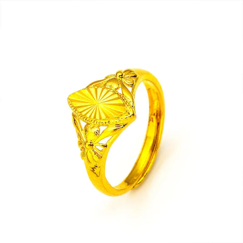 Gold coloured electroplated brass ring with a geometric open diamond flower design and textured details.