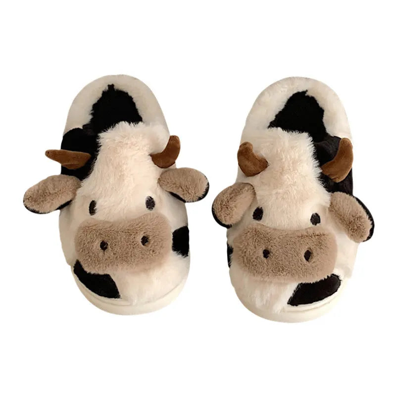 White plush cow-themed house slippers for women with a non-slip textured sole.
