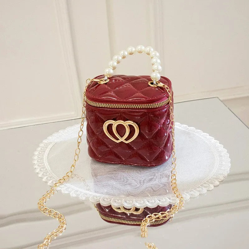Women's PVC bucket handbag with heart pattern in various colours including red, black, and yellow
