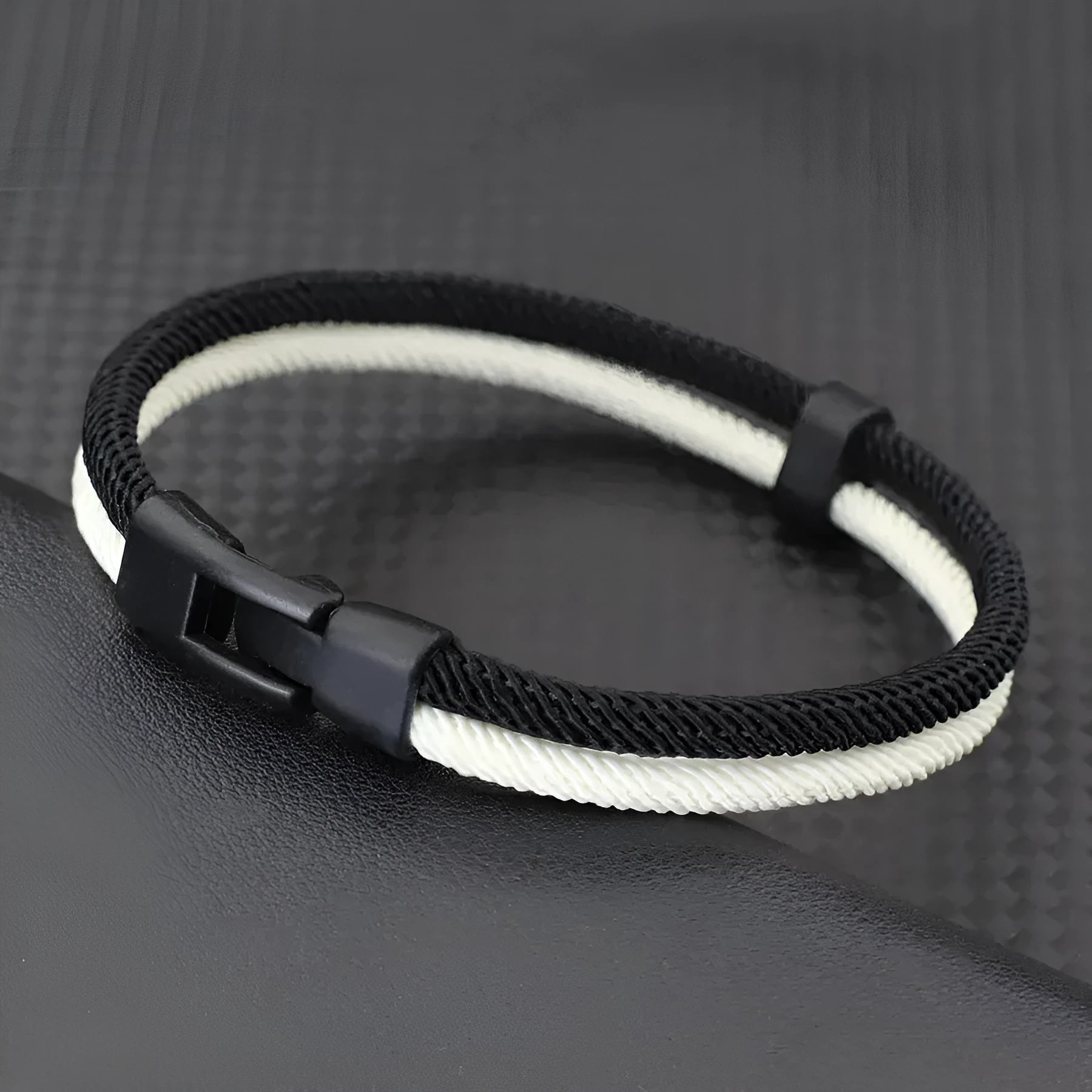 Black and white woven Milan rope alloy hand strap showing handmade construction detail