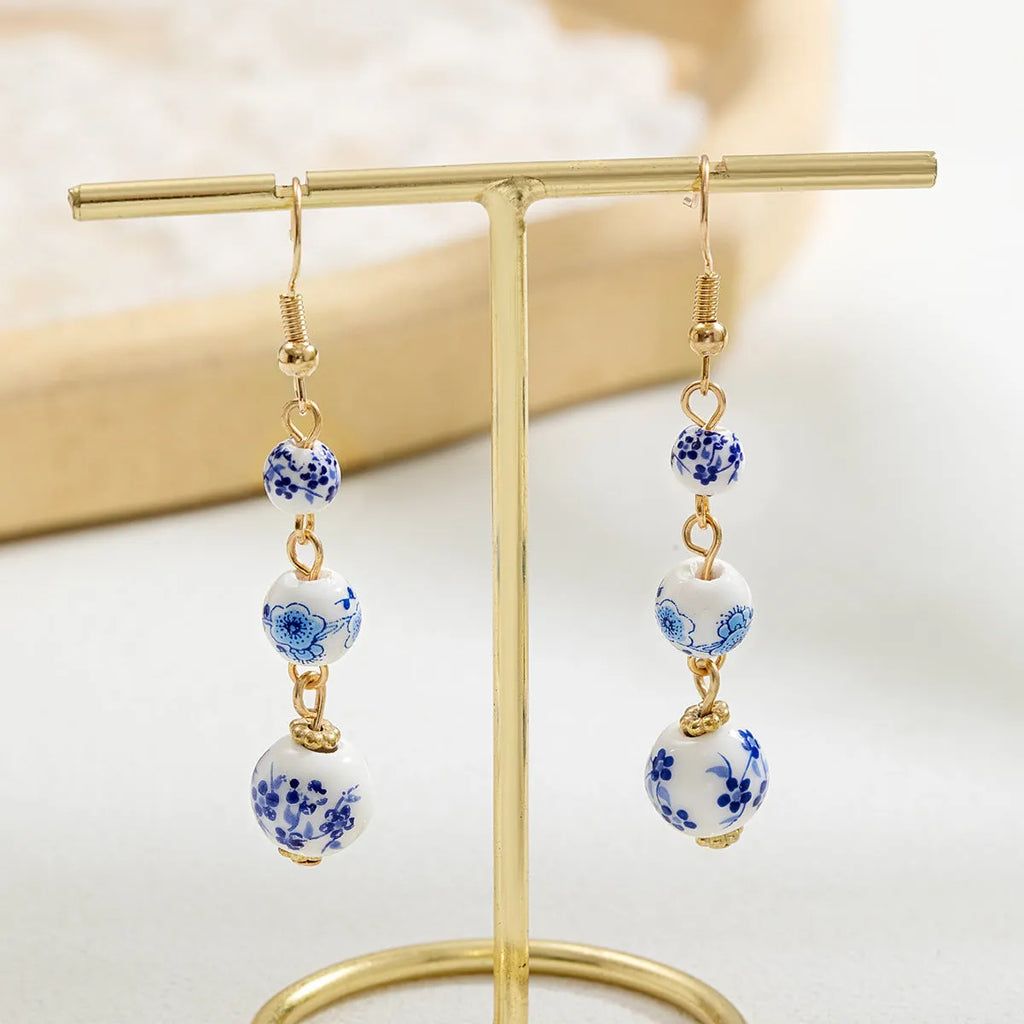 Blue and white porcelain ceramic bead retro earrings with geometric alloy components
